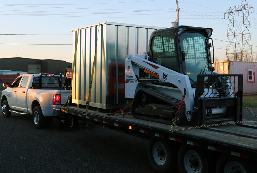 Container placement using a Bobcat or forklift.