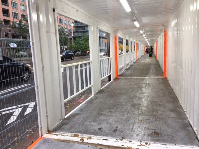 Shipping containers used on Bay St as hoardings for new construction.