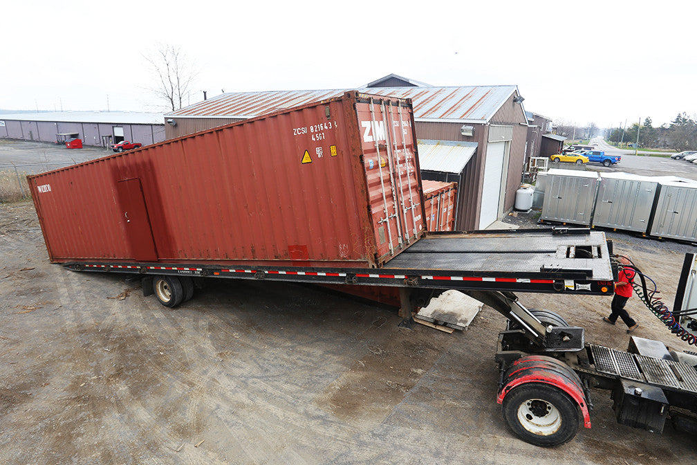 Loading up a modified shipping container for delivery.